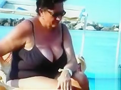 Large saggy breasts in bikini tops by the pool