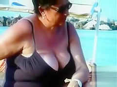 Large saggy breasts in bikini tops by the pool
