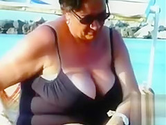 Large saggy breasts in bikini tops by the pool