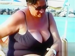 Large saggy breasts in bikini tops by the pool