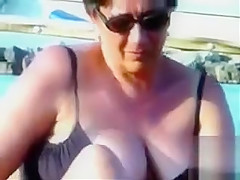 Large saggy breasts in bikini tops by the pool