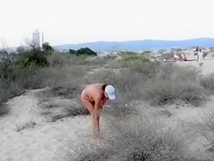 Exhibitionist wife is naked on the sandy beach