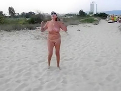 Exhibitionist wife is naked on the sandy beach
