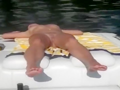 Naked woman sleeps on the boat as he films