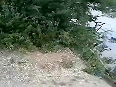 Slender nudist goes for a swim in the lake