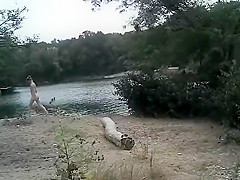 Slender nudist goes for a swim in the lake