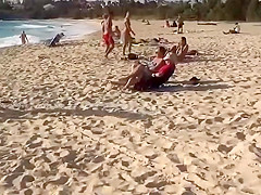 Topless girl on the beach has a nice booty