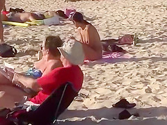 Topless girl on the beach has a nice booty