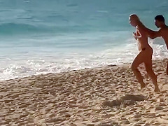 Topless girl on the beach has a nice booty