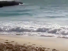 Topless girl on the beach has a nice booty