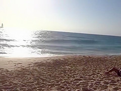 Topless girl on the beach has a nice booty