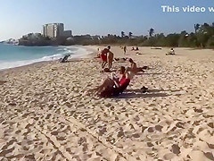Topless girl on the beach has a nice booty