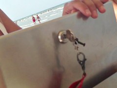 Busty girl selling ice-creams on the beach