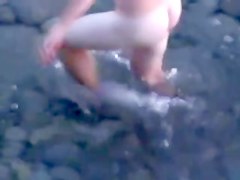 Brunette licks thecock gently at the beach