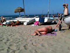 Flawless topless blond butt on the beach