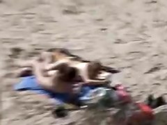 A Voyeur films a pair on beach