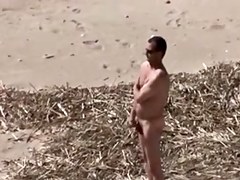 A Voyeur films a pair on beach