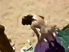 Horny couple fucks in a voyeur sex on the beach video
