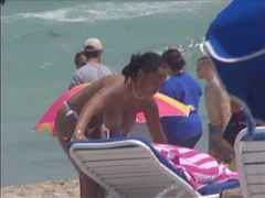 Plump breasted girl caught in a voyeur beach nudism video