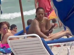 Plump breasted girl caught in a voyeur beach nudism video