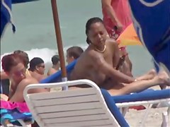 Plump breasted girl caught in a voyeur beach nudism video