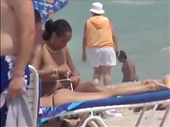 Plump breasted girl caught in a voyeur beach nudism video
