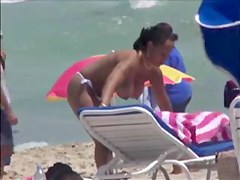 Plump breasted girl caught in a voyeur beach nudism video