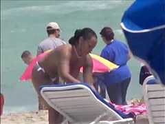 Plump breasted girl caught in a voyeur beach nudism video