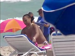 Plump breasted girl caught in a voyeur beach nudism video