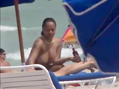 Plump breasted girl caught in a voyeur beach nudism video