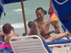 Plump breasted girl caught in a voyeur beach nudism video