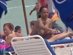Plump breasted girl caught in a voyeur beach nudism video