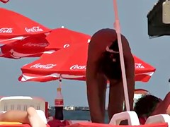 Busty girl shows her mighty jugs on a nudist beach