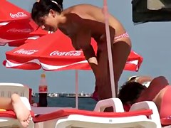 Busty girl shows her mighty jugs on a nudist beach