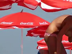 Busty girl shows her mighty jugs on a nudist beach