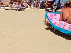 Round tan arse on the beach