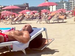 Round tan arse on the beach