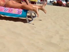 Round tan arse on the beach