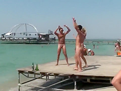 Topless babe dancing with naked guys in public
