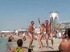Topless babe dancing with naked guys in public