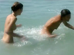 Naked brunette teens splash in the lake