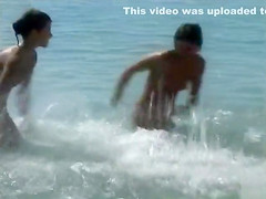 Naked brunette teens splash in the lake