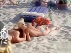 Doing the fellatio on a crowded beach