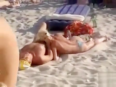 Doing the fellatio on a crowded beach