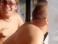 Doing the fellatio on a crowded beach
