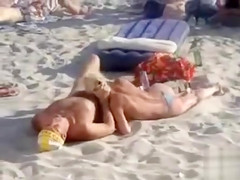 Doing the fellatio on a crowded beach