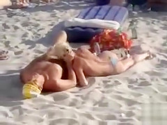 Doing the fellatio on a crowded beach