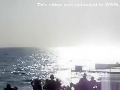 Doing the fellatio on a crowded beach