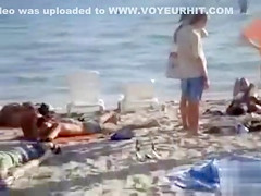 Doing the fellatio on a crowded beach