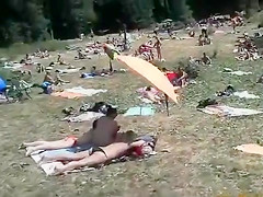 Nudist camp at the lake with lots of men and women